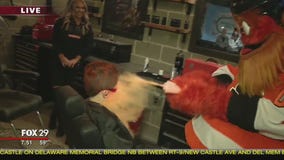 Jenn hangs with Gritty in the new C.O.M.M.A.N.D. Center ahead of home opener