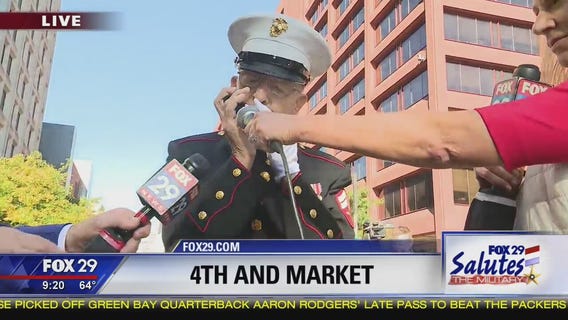 Military veteran Roland Scarinci plays America the Beautiful on harmonica