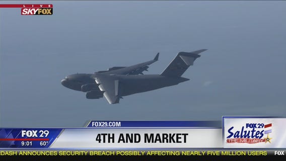 C-17 transport aircraft flies over Market Street