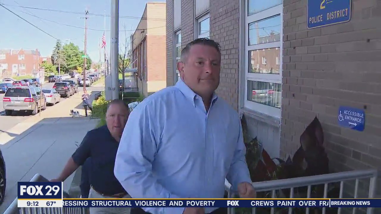 Inspector Bologna surrenders after being charged with striking protester