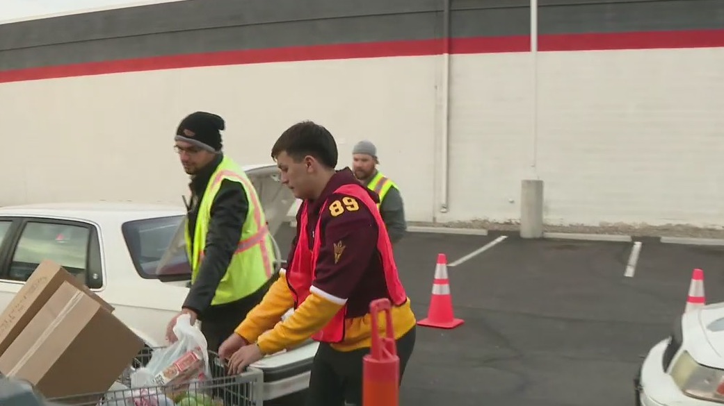 ASU football players help distribute food boxes at St. Mary's Food Bank