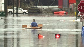 Man takes canoe for a ride through floodwater in Seattle