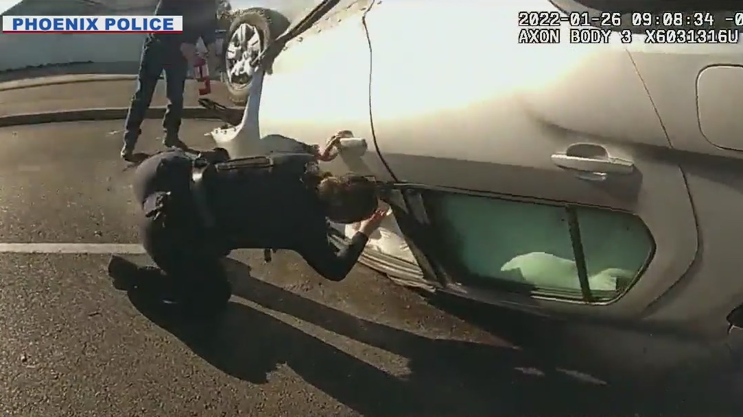 Police officers pull man from burning car after rollover crash in ...