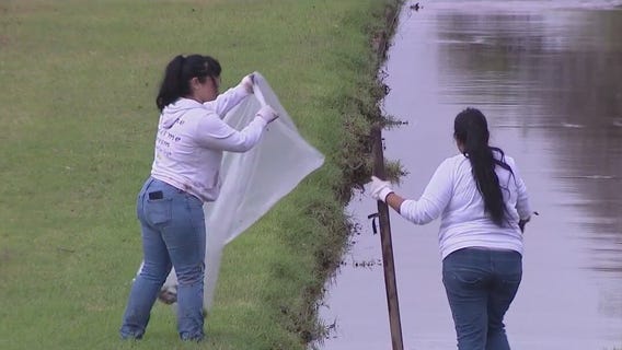 Student volunteers clean up canal after recent storms