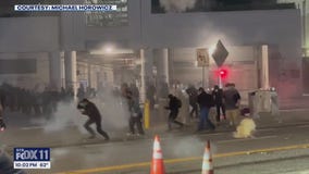Agents in riot gear toss smoke bombs, explosions in LA