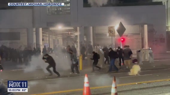 Agents in riot gear toss smoke bombs, explosions in LA