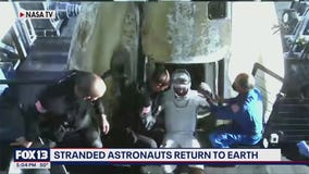Stranded astronauts return to earth