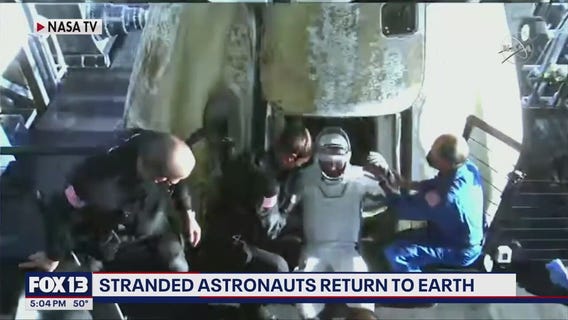 Stranded astronauts return to earth