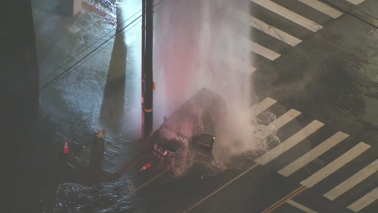 Car stuck after fire hydrant explodes in LA's Exposition Park