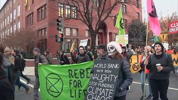 Climate change protesters march through DC streets