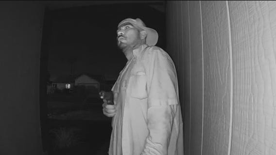 Home security camera captures unknown suspect pointing gun at front door of Phoenix home