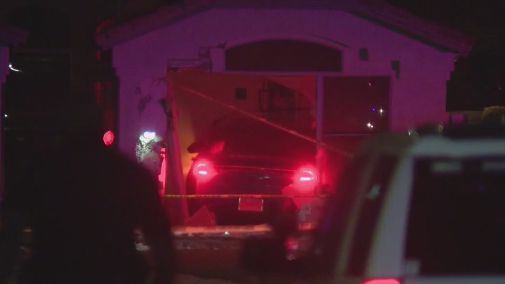 Woman arrested, accused of crashing car into home