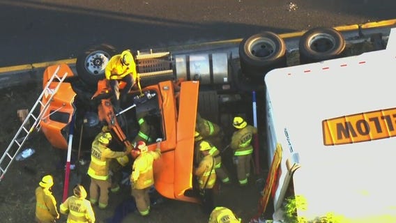 Crews work to rescue truck driver on 710 Freeway in Long Beach
