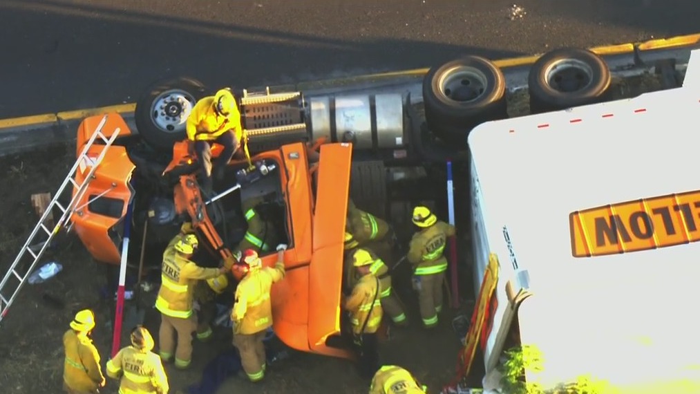 Crews work to rescue truck driver on 710 Freeway in Long Beach