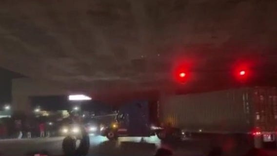 Oakland sideshow crowd cheers big rig driver