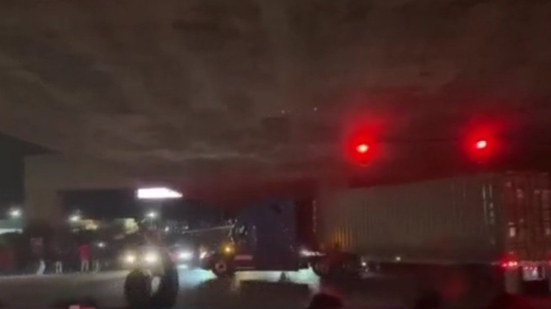 Oakland sideshow crowd cheers big rig driver