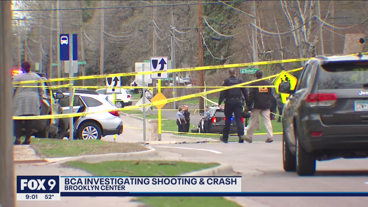Protesters gather near the scene where a man died after being shot by police in Brooklyn Center