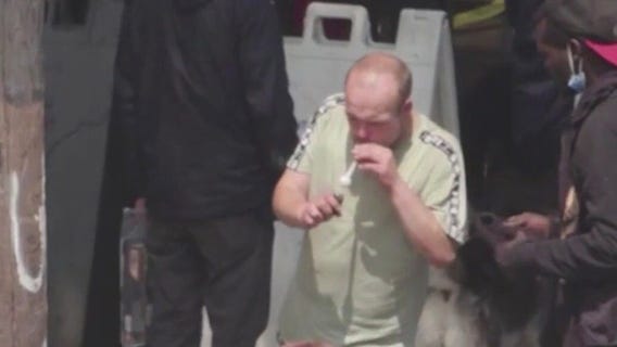 Homeless walking out of nonprofit with crack pipe