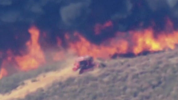 Fire dozer fights Hughes Fire in Castaic