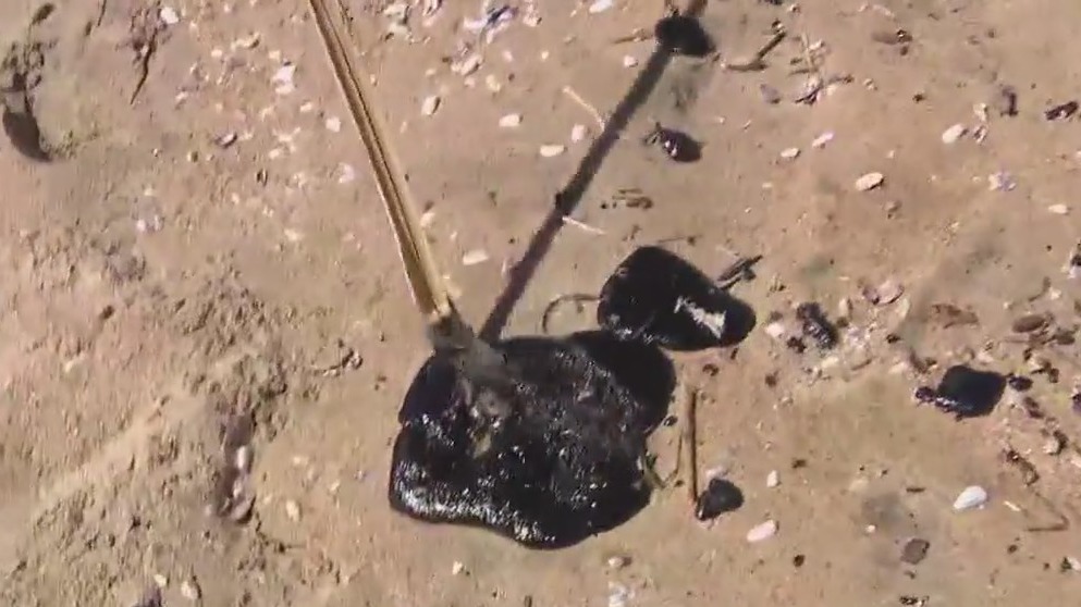 Tar balls still turning up in Huntington Beach