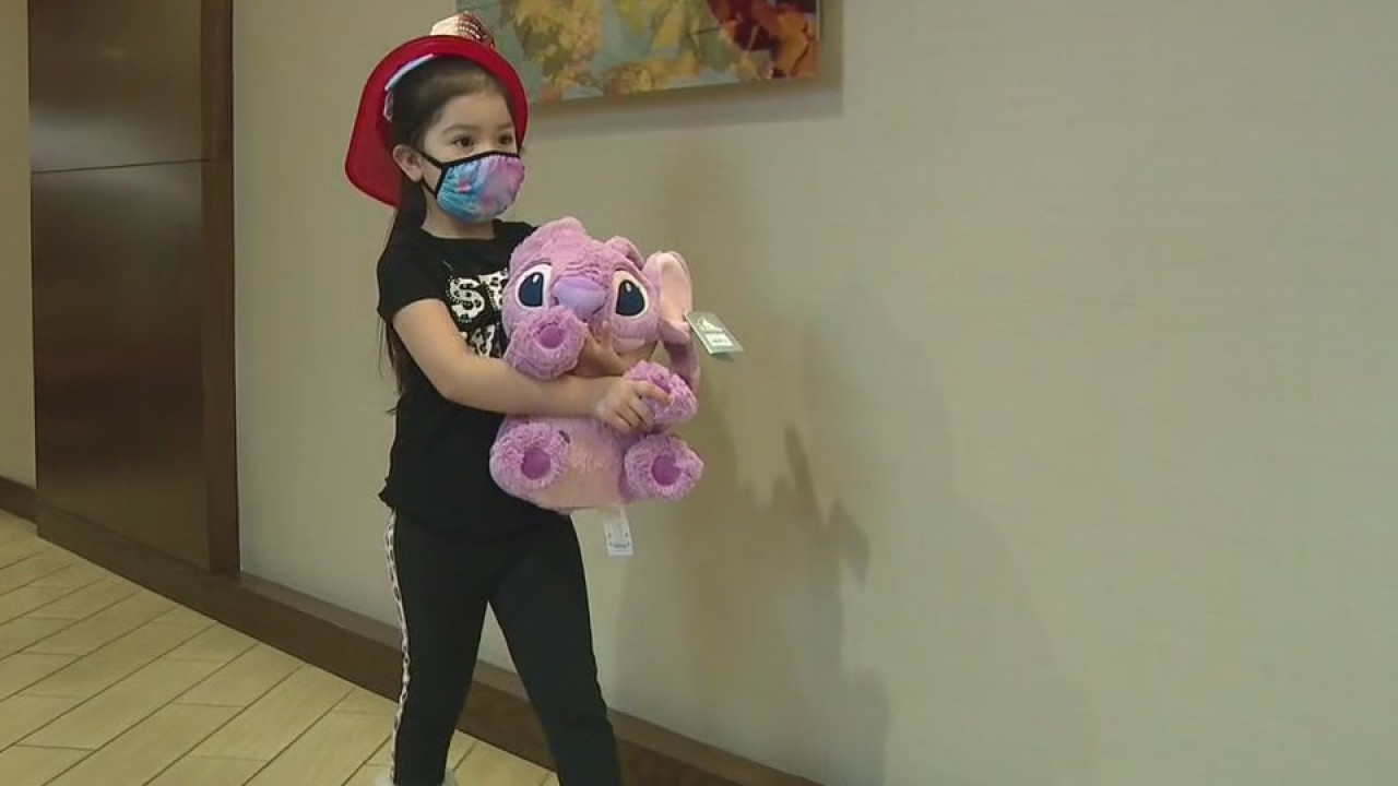 Firefighters give Christmas presents to fire victims