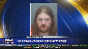 Uber driver accused of robbing passenger