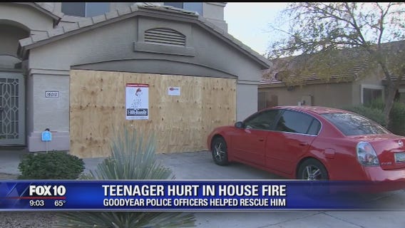 Police officers rescue teen trapped inside burning home