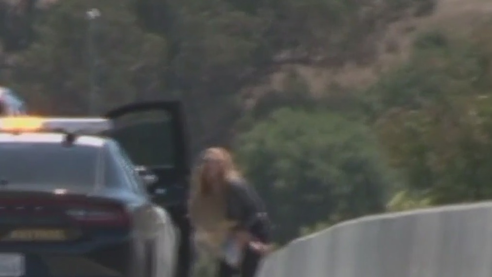 Woman arrested after driving erratically with child on lap