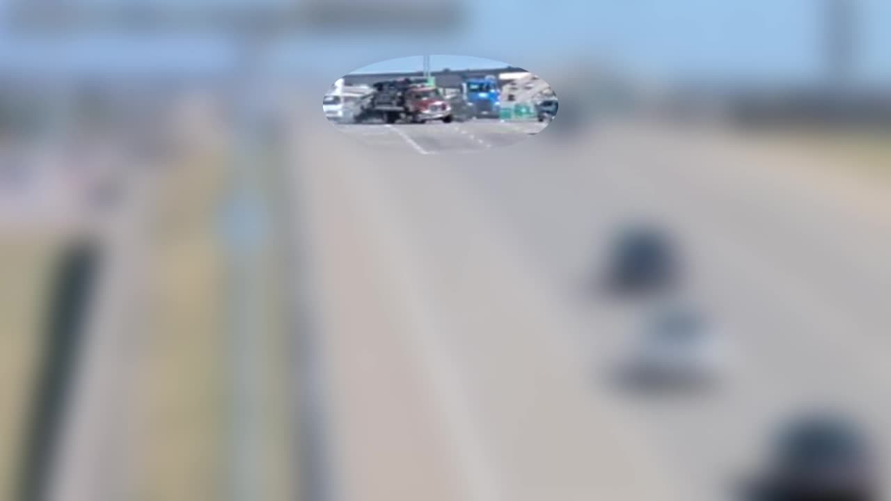 VIDEO: Crash leaves tow truck dangling off overpass