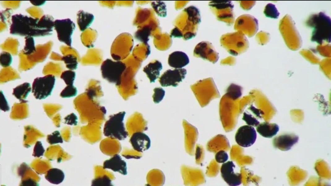 Why is the moon covered in orange glass beads?