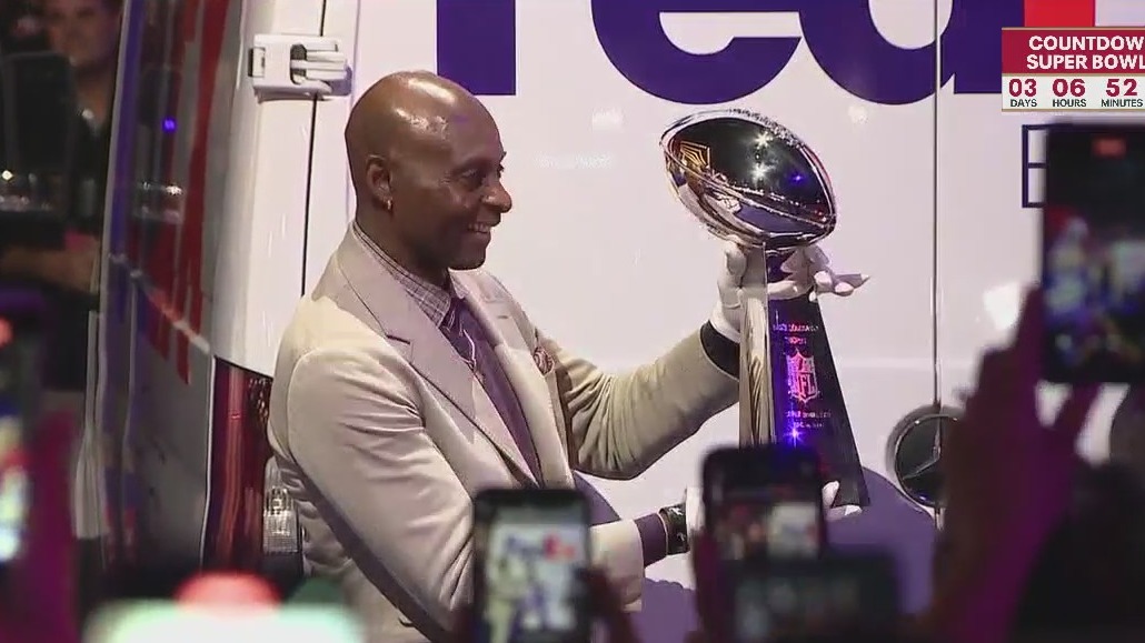 Former Niner Jerry Rice holds the silver Super Bowl trophy