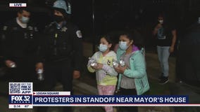 Kids give water bottles to Chicago police during Adam Toledo protest