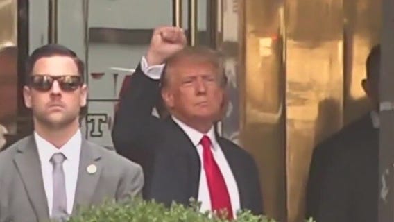 Trump waves to supporters ahead of turning himself in