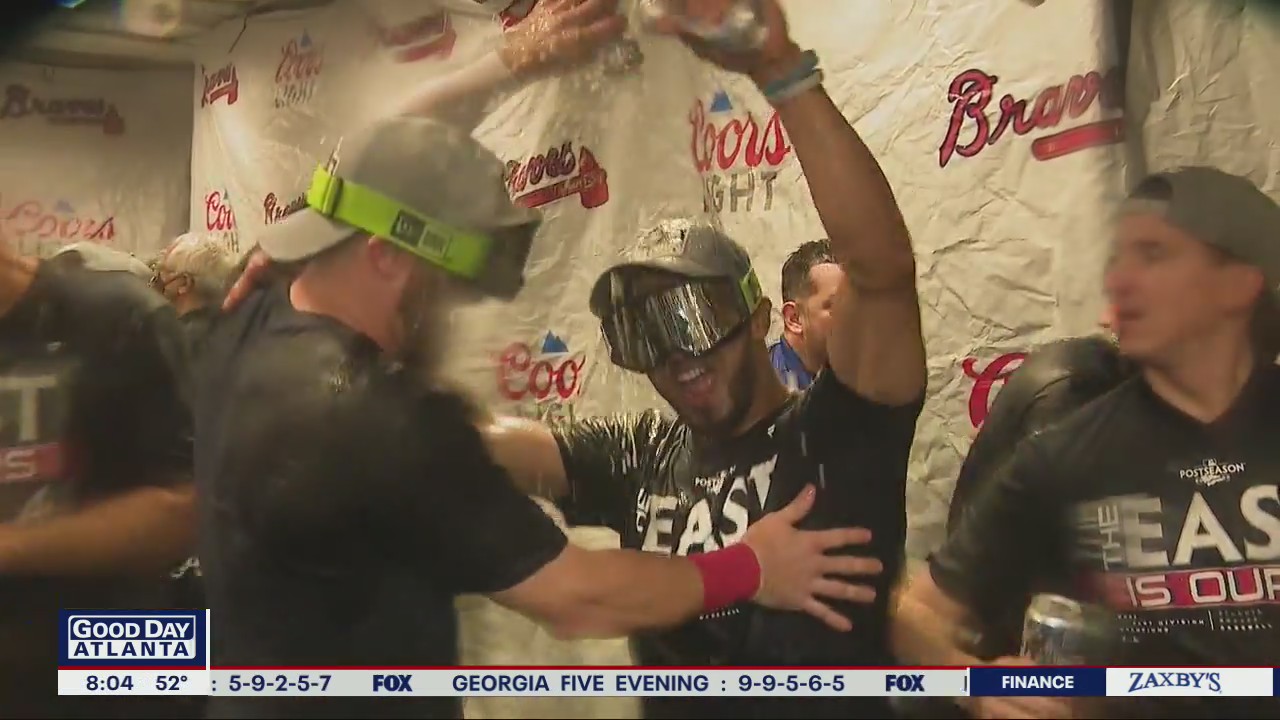 Atlanta Braves pop champagne after winning NL East division title
