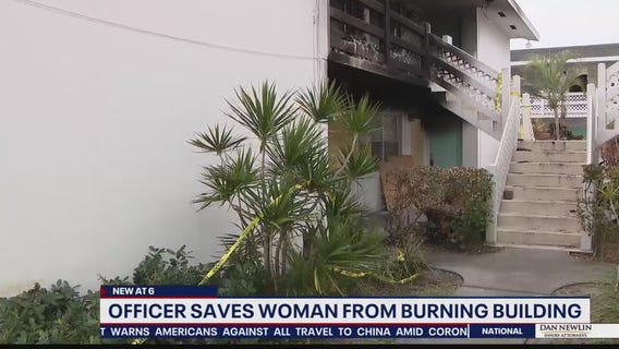 Officer saves woman from burning building