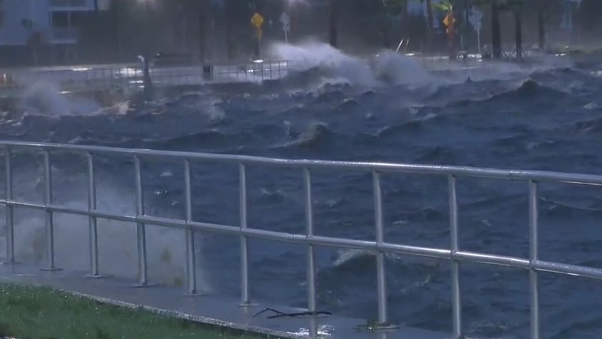 Waves crash over walls at Lake Monroe during Tropical Storm Nicole