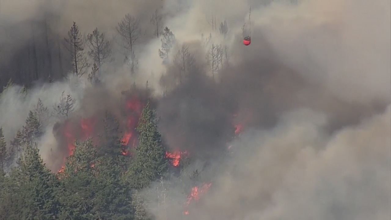 Helicopter drops water on top of San Mateo/Santa Cruz Co. fire