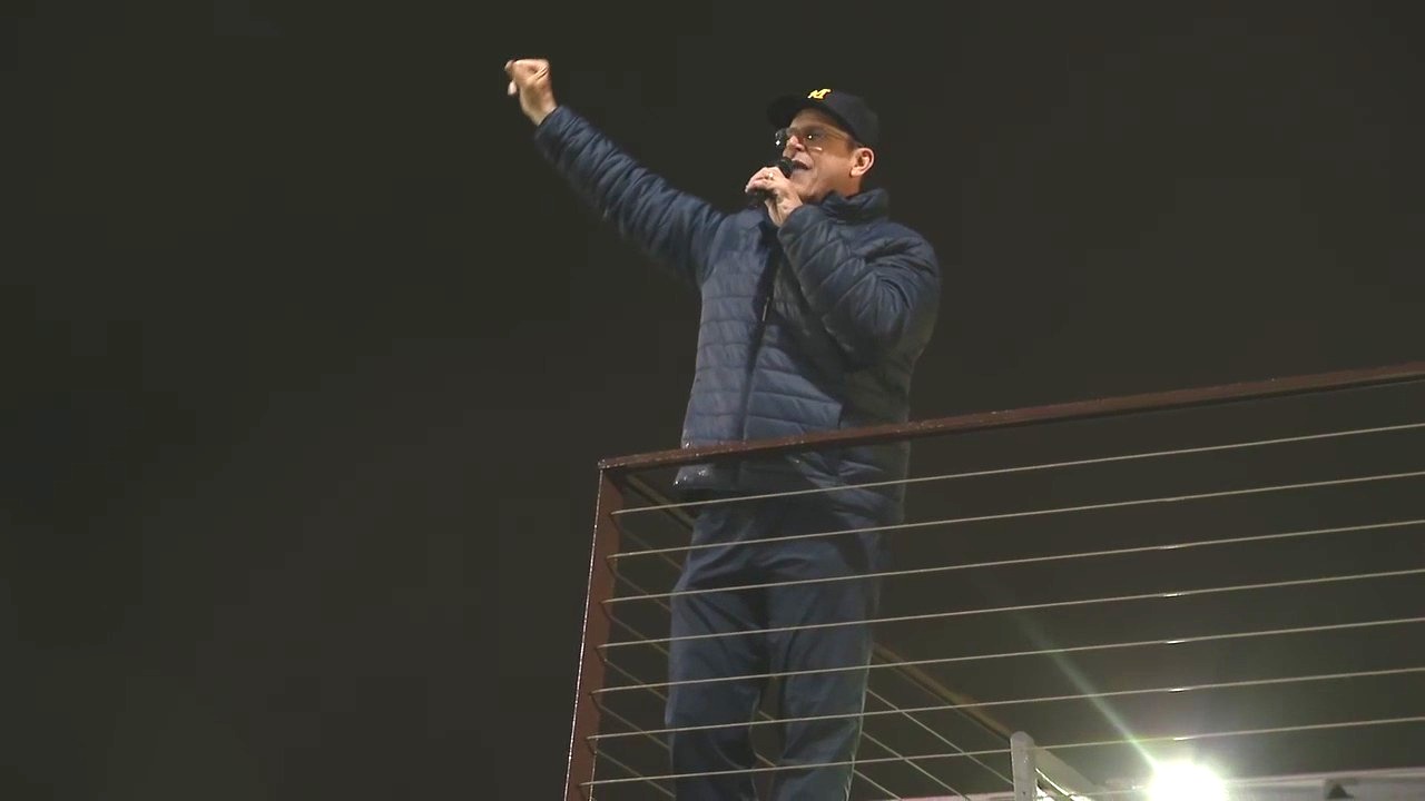 Coach Harbaugh and Kris Jenkins address the crowd