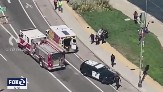 Witnesses say innocent bystander at Lake Merritt  struck by stray bullet resulting from a gun battle between people  2 vehicles