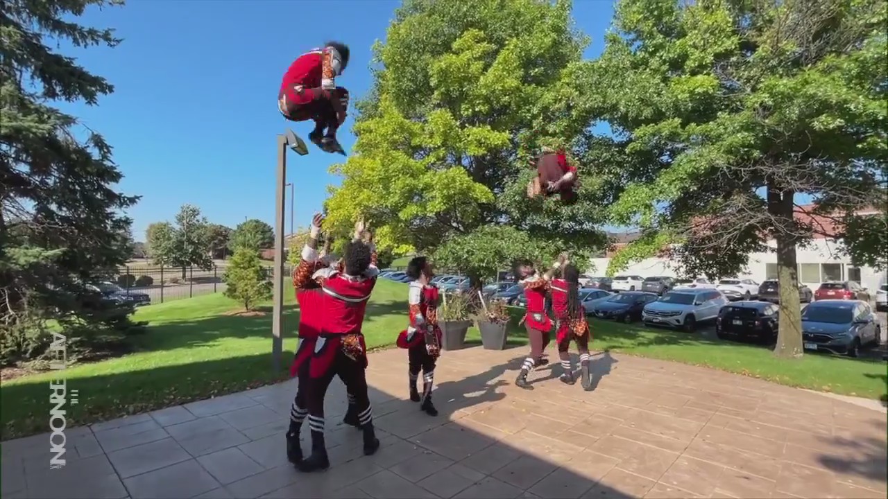 Troop Ethiopia acrobats fly through the air