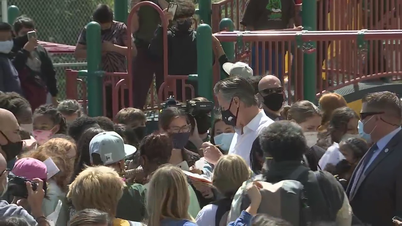 Gov. Newsom signs autographs for school children in Oakland