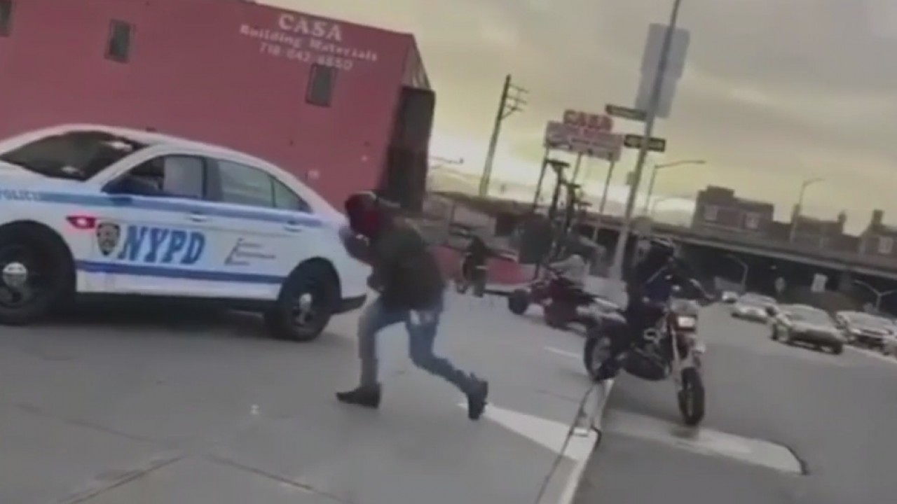 Dirt bikes surround cop