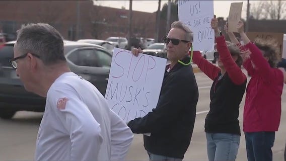 Protesters gather at Schaumburg Tesla dealership