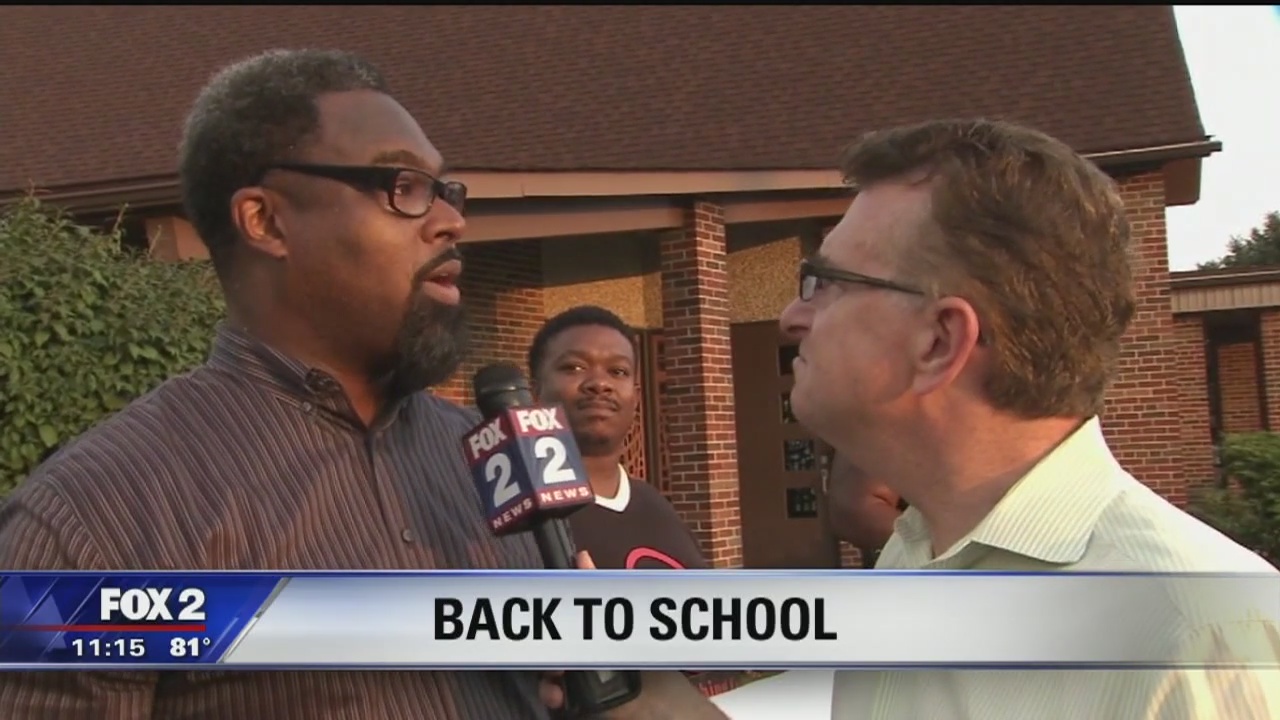 Black men gather to cheer on students returning to school in Detroit