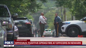 NJ fugitive fires shots at officers in standoff involving baby