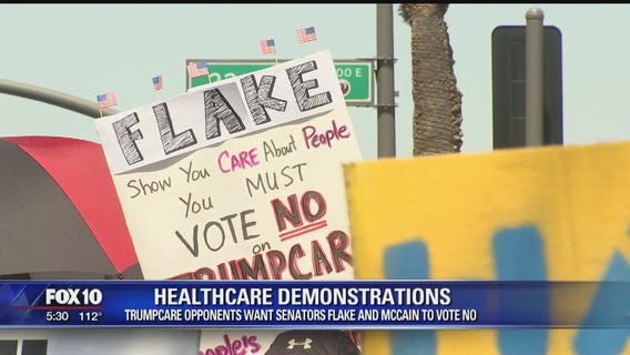 Demonstrators protest outside McCain and Flake's offices before vote on AHCA bill
