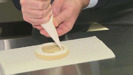 Frosting cookies at Yaya's Sweet Treats