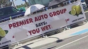 Offensive banner at middle of dispute between car dealership and union