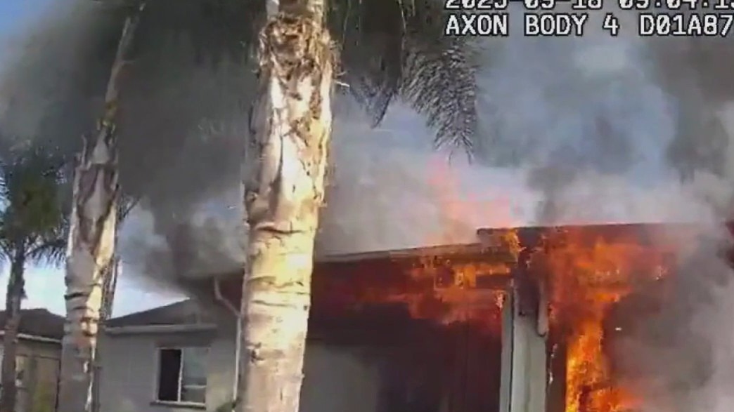 Officers rescue woman from burning home