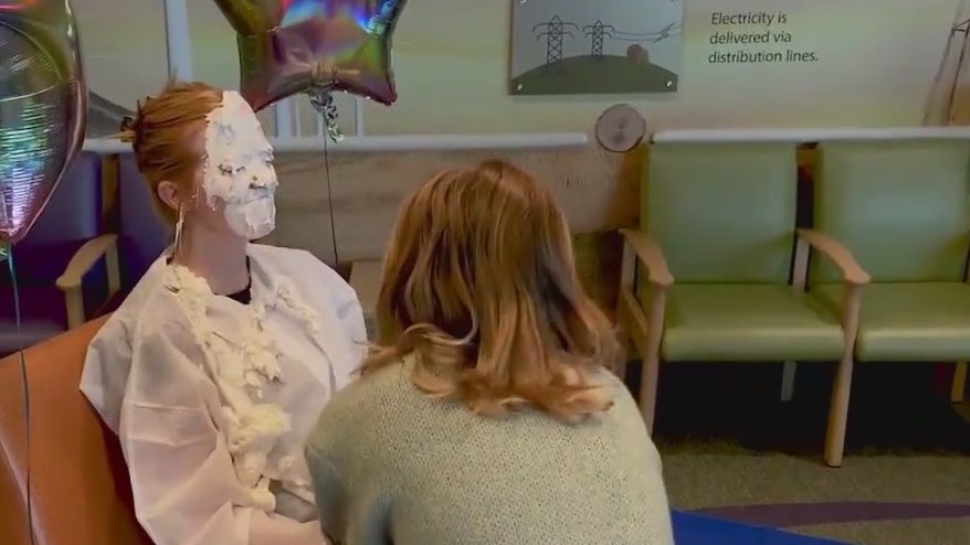 Cancer survivor celebrates by giving nurse pie in face